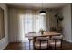 Bright dining area with wood flooring and light filtering curtains at 9016 Pyrus St, Kissimmee, FL 34747