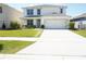 Charming two-story home featuring a well-manicured lawn and a convenient two-car garage at 9016 Pyrus St, Kissimmee, FL 34747