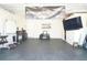 Bright garage features a TV, equipment, and vehicle, offering a versatile space for various activities at 9016 Pyrus St, Kissimmee, FL 34747