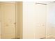 Hallway featuring two doors with one closed and the other slightly open, bright color scheme at 9016 Pyrus St, Kissimmee, FL 34747