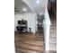 Hallway view showcasing wood floors leading to a living space and staircase to the second floor at 9016 Pyrus St, Kissimmee, FL 34747