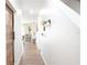 Bright hallway boasts modern decor, wood-look floors, and a rustic barn door, blending style and functionality at 9016 Pyrus St, Kissimmee, FL 34747