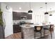 Modern kitchen featuring an island, granite countertops, stainless steel appliances, and dark wood cabinets at 9016 Pyrus St, Kissimmee, FL 34747