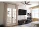 Comfortable living room featuring a ceiling fan and entertainment center at 9016 Pyrus St, Kissimmee, FL 34747