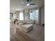 Sunlit living room with large windows, comfortable seating, and stylish striped rug at 9016 Pyrus St, Kissimmee, FL 34747