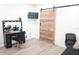 Bright room with a vanity, a chair and a wooden sliding door for maximum space at 9016 Pyrus St, Kissimmee, FL 34747