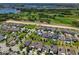 Neighborhood aerial view with houses, golf course, lake, and lush greenery at 9056 Pinch Shot Dr, Winter Garden, FL 34787