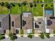 Overhead view of several homes with solar panels and lush green backyards, showcasing meticulous landscaping at 9056 Pinch Shot Dr, Winter Garden, FL 34787