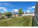 The fenced backyard features well-maintained green grass and strategically planted trees at 9056 Pinch Shot Dr, Winter Garden, FL 34787