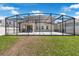 View of screened-in patio and well-maintained lawn, perfect for outdoor relaxation at 9056 Pinch Shot Dr, Winter Garden, FL 34787
