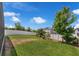 Expansive fenced backyard showcasing lush green grass and mature trees at 9056 Pinch Shot Dr, Winter Garden, FL 34787