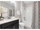 Bright bathroom with white tiled shower/tub, modern vanity, and decorative accents at 9056 Pinch Shot Dr, Winter Garden, FL 34787