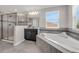 Bathroom featuring a glass shower, bathtub, a vanity, and a window at 9056 Pinch Shot Dr, Winter Garden, FL 34787