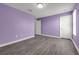 Bedroom with hardwood floors, two large windows, and neutral walls offering a versatile and inviting space at 9056 Pinch Shot Dr, Winter Garden, FL 34787