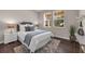 Cozy bedroom with large windows, plush bedding, stylish decor, and wood flooring at 9056 Pinch Shot Dr, Winter Garden, FL 34787