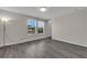 Bedroom with hardwood floors, two windows letting in natural light, and a neutral color scheme creating a serene atmosphere at 9056 Pinch Shot Dr, Winter Garden, FL 34787