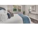 Comfortable bedroom with ample natural light and neutral tones, featuring a plush bed and decorative elements at 9056 Pinch Shot Dr, Winter Garden, FL 34787