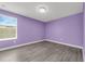 Bright bedroom with hardwood floors and a large window allowing for natural light to create a welcoming ambiance at 9056 Pinch Shot Dr, Winter Garden, FL 34787
