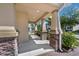 Spacious covered porch with stone-accented columns, offering a welcoming entrance and an elegant outdoor space at 9056 Pinch Shot Dr, Winter Garden, FL 34787
