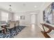 Formal dining room with modern furnishings, including a wooden table and eye-catching blue rug at 9056 Pinch Shot Dr, Winter Garden, FL 34787