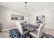 Elegant dining room featuring a modern table set, stylish blue rug, and decorative wall art at 9056 Pinch Shot Dr, Winter Garden, FL 34787