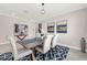 Elegant dining room with a blue patterned rug and view of the staircase and entry at 9056 Pinch Shot Dr, Winter Garden, FL 34787