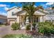 Charming two-story home featuring a covered porch with stone accents and beautifully landscaped front yard at 9056 Pinch Shot Dr, Winter Garden, FL 34787