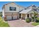 Charming home featuring a two-car garage, a covered entrance, and a well-manicured lawn at 9056 Pinch Shot Dr, Winter Garden, FL 34787