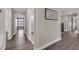 Hallway featuring wood-look floors and multiple doorways at 9056 Pinch Shot Dr, Winter Garden, FL 34787