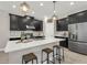 Modern kitchen boasts dark cabinets, stainless appliances, white countertops and island seating at 9056 Pinch Shot Dr, Winter Garden, FL 34787