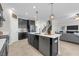 Contemporary kitchen with dark cabinets, stainless steel appliances, and island with white countertops at 9056 Pinch Shot Dr, Winter Garden, FL 34787