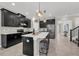Stylish kitchen featuring dark cabinetry, stainless steel appliances, and a large island with pendant lighting at 9056 Pinch Shot Dr, Winter Garden, FL 34787