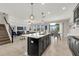 Open concept kitchen and living area featuring a large island and lots of natural light at 9056 Pinch Shot Dr, Winter Garden, FL 34787