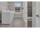 Well-lit laundry room with side-by-side washer and dryer, tiled flooring, and a window for natural light at 9056 Pinch Shot Dr, Winter Garden, FL 34787