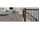 Spacious living area with hardwood floors, comfortable seating, and a modern staircase at 9056 Pinch Shot Dr, Winter Garden, FL 34787