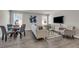 Open-concept living area with contemporary furniture, large windows, and sleek hardwood floors at 9056 Pinch Shot Dr, Winter Garden, FL 34787
