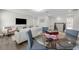 Inviting living room featuring a flat screen television, comfortable seating, and a cozy dining area at 9056 Pinch Shot Dr, Winter Garden, FL 34787