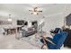 Open-concept living room and kitchen area featuring modern decor, sleek furniture, and a view of the staircase at 9056 Pinch Shot Dr, Winter Garden, FL 34787