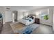 Bright main bedroom with natural light, plush bedding, and stylish hardwood floors at 9056 Pinch Shot Dr, Winter Garden, FL 34787