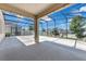 Large screened-in patio with ample space for outdoor living and entertaining, overlooking a well-maintained yard at 9056 Pinch Shot Dr, Winter Garden, FL 34787