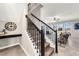 Elegant staircase with dark metal railing, wood steps, leading to the upstairs living area at 9056 Pinch Shot Dr, Winter Garden, FL 34787