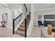 Stylish staircase with dark railing and wooden steps, seamlessly connecting living spaces at 9056 Pinch Shot Dr, Winter Garden, FL 34787