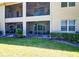 Exterior view of condo balconies with screened patios overlooking a well-maintained lawn at 9435 Myrtle Creek Ln # 304, Orlando, FL 32832