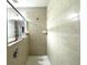 Well-lit shower features neutral tile, glass partition, and built-in soap holder at 9435 Myrtle Creek Ln # 304, Orlando, FL 32832