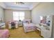 Large bedroom featuring two beds, a ceiling fan, and vanities near a window for natural light at 9435 Myrtle Creek Ln # 304, Orlando, FL 32832