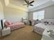Large bedroom with carpet, a ceiling fan, and two beds with large windows for natural light at 9435 Myrtle Creek Ln # 304, Orlando, FL 32832