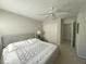 Carpeted bedroom featuring neutral walls, a ceiling fan, and a comfortable queen size bed at 9435 Myrtle Creek Ln # 304, Orlando, FL 32832