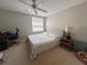 Bedroom featuring neutral walls, carpeted floors, a ceiling fan, and a comfortable queen size bed at 9435 Myrtle Creek Ln # 304, Orlando, FL 32832