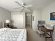 Bedroom featuring neutral paint, carpeted floors, desk, and a window providing natural light at 9435 Myrtle Creek Ln # 304, Orlando, FL 32832