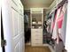 Well-organized walk-in closet with shelving, hanging rods, drawers, and ample storage space at 9435 Myrtle Creek Ln # 304, Orlando, FL 32832